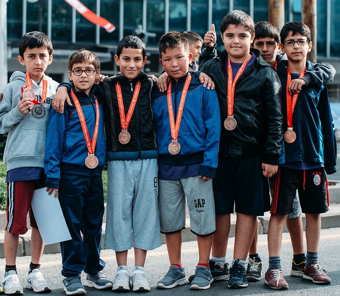 Group of children with medals who participated in Little Lives UK sponsored sport activity